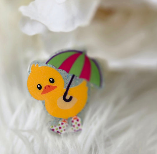 Ducky with pink and green umbrella badge reel
